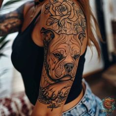 a woman with a tattoo on her arm and dog in the middle of her arm