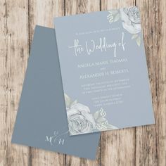 two wedding cards on top of each other next to a wooden background with the word, the wedding of