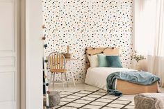 a bedroom with polka dot wallpaper and a bed