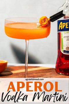 the aperol vodka martini is garnished with an orange flower