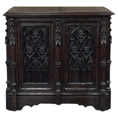 an old wooden cabinet with carvings on the front and sides, isolated against a white background