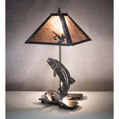 a fish lamp on a table with a shade over it's head and bottom