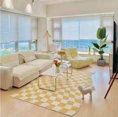 a living room filled with furniture and a flat screen tv on top of a hard wood floor