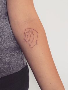 a woman's arm with a tattoo of a dog on the left side of her arm