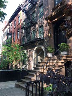 an apartment building with stairs leading up to it