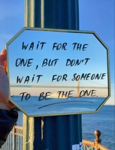 someone holding up a sign that says wait for the one, but don't wait for someone to be the one