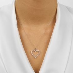 Hearts symbolize love and commitment, which makes this gorgeous 14K Gold open heart pendant necklace the perfect gift to give to that special someone in mind. A choice of 1/4, 1/2, or 1 CTW of sparkling round brilliant cut diamonds are nestled in secure single prong settings on the front of this contemporary slim heart that hangs on a tapered bail. This exquisite pendant is also available in 14K White, Yellow, and Rose Gold. A sturdy 18'' chain is threaded through the top, making this diamond he White Diamond Heart Necklace For Anniversary, Heart-shaped Necklace With Prong Setting For Wedding, Wedding Heart Necklace With Brilliant Cut, Heart-shaped Wedding Necklace With Prong Setting, Heart Shaped Wedding Necklace With Prong Setting, Elegant Heart Necklace With Prong Setting For Valentine's Day, Elegant Prong-set Heart Necklace For Valentine's Day, Heart Cut Diamond Accents Heart Necklace For Anniversary, Heart Cut Diamond Accented Heart Necklace For Anniversary