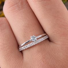 a woman's hand with a diamond ring on it