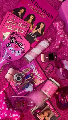 the contents of a pink bag are spread out