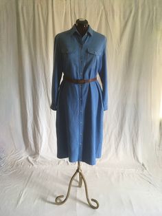 "vintage 1970s shirt dress LL Bean pure silk, slight nubby w/white undertones to weave button up long sleeve smoky blue collared w/point stays breast pocket w/button flaps side pockets about mid calf length, depending on wearer's height good vintage condition, light wear-see photos, light fade,slub, nothing major belt not included labeled size 14, see below measures, lying flat, shoulder-16\" chest-21\" waist-20 1/2\" hip-22\" sleeve-22 1/2\" length from top shoulder-46\"" Fall Relaxed Fit Shirt Dress With Spread Collar, Fitted Mid-length Shirt Dress For Daywear, Classic Spring Shirt Dress With Relaxed Fit, Classic Cotton Shirt Dress For Fall, Classic Long Sleeve Summer Shirt Dress, Classic Relaxed Fit Shirt Dress For Spring, Fitted Long Sleeve Shirt Dress With Pockets, Fitted Long Shirt Dress With Buttons, Fitted Midi Shirt Dress For Fall