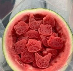 a watermelon with hearts carved into the inside is shown in plastic wrappers