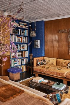 a living room filled with furniture and bookshelves