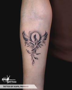 a tattoo on the leg of a person with a bird in it's wings