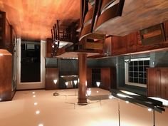 an empty room with wooden cabinets and lights