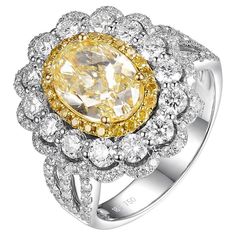 This exquisite ring features a central yellow diamond, IGI certified and weighing 2.29 carats with an N color grading, which exhibits a warm, sunlit hue. Set in 18 karat white gold, this resplendent gemstone is the star of a triple halo setting, a testament to opulence and detailed craftsmanship. The primary halo encircling the yellow diamond consists of fancy yellow diamonds totaling 0.14 carats. These diamonds provide a seamless transition in color, enhancing the vividness of the central stone Light Yellow Diamond, Fancy Light, Yellow Diamonds, Fancy Lights, Fancy Yellow Diamond, Halo Setting, Color Grading, Halo Ring, Halo Rings