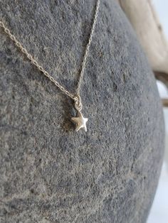 "Beautiful. Delicate Tiny Sterling Silver 6mm (0.23 inches) star charm hangs delicately from a Sterling Silver chain. It has a slightly puffed shape. Made from aold sterling silver, it is a great every day necklace. Shown in 17\" length. Please message me if you would like more than the quantity listed. I can produce custom orders of any quantity within a week. Visit my shop: http://www.etsy.com/shop/Jadedslo All items are individually hand assembled and I guarantee the workmanship and quality o Minimalist Star Charm Pendant Necklace, Dainty Star-shaped Charms Jewelry, Dainty Star Shaped Charms Jewelry, Star-shaped Charm Necklaces For Gifts, Minimalist Star Shaped Jewelry With Star Charm, Dainty Star-shaped Necklace With Starfish Charm, Delicate Star Charm Pendant Necklace, Simple Star Charm Jewelry Gift, Silver Star Charm Necklace