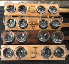 wine glasses are lined up on a wooden rack