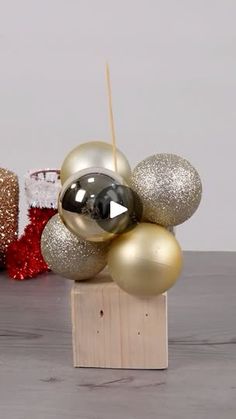 some gold and silver ornaments on a wooden block