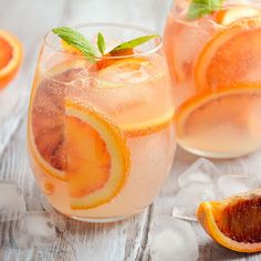 two glasses filled with water and orange slices