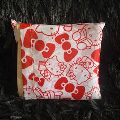 a red and white hello kitty pattern on a black background