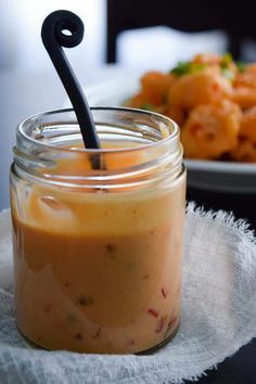 a glass jar filled with food sitting on top of a table