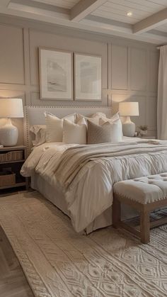 a large white bed sitting in a bedroom next to two lamps on either side of the bed