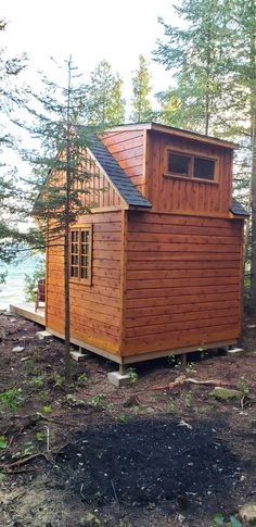 a small wooden cabin sitting in the woods