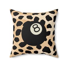 an animal print pillow with a eight ball on it