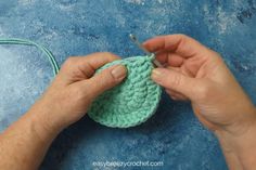 someone is crocheting an apple with yarn