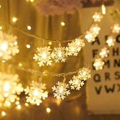 snowflake lights are hanging from a string