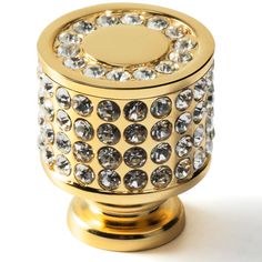 a gold colored knob with lots of diamonds on it