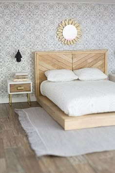 a bedroom with a bed, nightstands and mirror on the wall above it's headboard