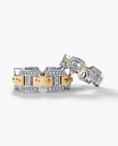 two yellow and white gold bracelets with diamonds on each side, set against a white background