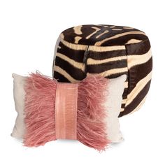 two zebra print pillows with pink ribbon on them and one in the shape of a hat