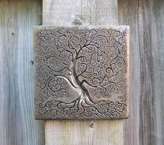 a metal plaque with a tree on it