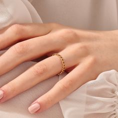 a woman's hand with a ring on it