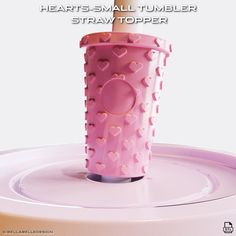 there is a pink cup with hearts on it