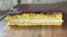 a piece of cake sitting on top of a wooden cutting board