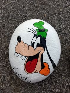 a painted rock with an image of mickey mouse on it's face and tongue