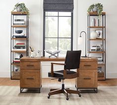 an office with a desk, chair and bookcases in front of a window