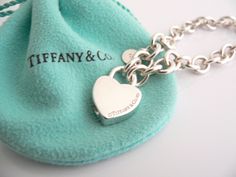 Offered for sale is a wonderful and rare Tiffany and Co. Sterling Silver "Love Match" Heart Padlock bracelet. The piece is made from substantial and bright Tiffany silver, and yet retains a very feminine feel to it. Attached to its very substantial Tiffany Silver charm bracelet is a Heart padlock charm with "Love Match" engraved on it. The"Love Match" padlock charm opens and closes and thus can be used as a charm on a necklace or as part of another charm bracelet! Super versatile piece! It is a Luxury Lock Jewelry For Gift, Heart-shaped Jewelry Gift With Clasp, Heart-shaped Jewelry With Clasp For Gifts, Luxury Wedding Heart Bracelet With Heart Charm, Luxury Sterling Silver Heart Bracelet For Gift, Luxury Heart Bracelet For Valentine's Day Formal, Lock Bracelet Jewelry Gift, Lock Jewelry For Valentine's Day Gift, Valentine's Day Gift Jewelry With Lock