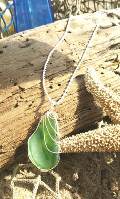 "~  A gorgeous lime green seaglass discovered on the four wheeled drive beaches on the northern coast of North Carolina. This wire decorated pendant measures 1\" x 2\" (wxh) including bail. I've hung this on a stunning and high reflective twisting chain made out of 925 Sterling Silver. This handmade and one of a kind necklace will shortly become an everyday favorite!! ~All Sea Jewels Jewelry come in a 4\" x 4\" white jewelry box, cushioned on sand colored satin material and tied with fine linen Green Sea Glass Necklaces For Jewelry Making, Wire Wrapped Sea Glass Pendant, Handmade Green Sea Glass Necklace, Silver Sea Glass Necklace With Wire Wrapped Detail, Handmade Ocean-inspired Sea Glass Necklaces, White Jewelry Box, Druzy Crystal, Gold Leaf Painting, Sterling Necklaces