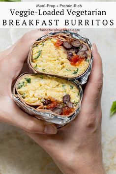 two breakfast burritos are being held in their hands with the words veggie loaded vegetarian breakfast burritos