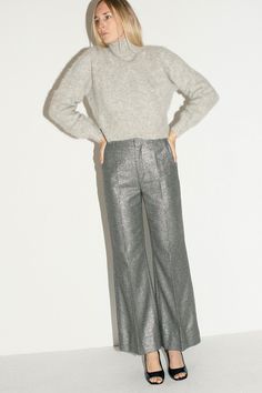 Shimmery trousers with a flared leg. Mid rise with a zip and hook and eye closure. Fabric is 60% recycled wool, 27% polyamide, 9% polyester, 4% other fibers. Ella is 6' tall, 36" bust, 27.5" waist, 38" hip, and is wearing a size S Grey Pants, Handmade Design, Modern Woman, Casual Pants, Mid Rise, Trousers, Sparkle, Wool, Pants