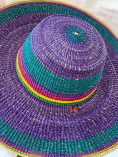 fashion handmade hat for 2023 . purple color hat perfect for any casual occasion such as beach party wear event or picnic party event . you can always immerse  in your own fashion groove style . #handmadehat #beachhat #beachaccesory  This can fit between 58 to 60 cm head circumference  A straw hat is a brimmed hat that is woven out of straw or straw-like materials from different plants.  the hat is designed  to protect the head from sun and against heatstroke The hat can also be used for wall de Womens Beach Hat, African Hats, Woven Hat, Purple Hat, African Crafts, Straw Hat Beach, Crown Hat, Trendy Hat, Purple Hats