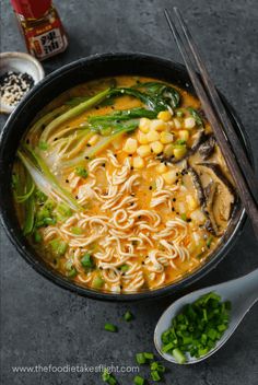 a bowl of soup with noodles and vegetables in it