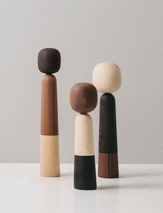 three wooden pegs sitting next to each other on top of a white countertop