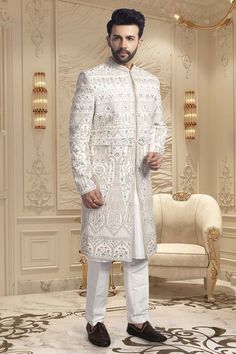 Crafted with intricate pearls and thread embroidery, the Mens Sherwani- U2-S350 is an exquisite choice for grooms. Its elegant design exudes sophistication, making it perfect for weddings. Elevate your wedding ensemble with this impeccable piece. Mens Sherwani, Thread Embroidery, Elegant Design, Thread, Weddings, Embroidery, Quick Saves, Design