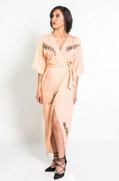 Make an entrance in our super sleek, figure-loving kimono wrap dress. Our top selling wrap dress is hand beaded with peacock feathers that will be sure to get you noticed and bring oodles of compliments everywhere you go. The romantic blush color is sure to make you fall head over heels in love, while our super soft natural fabric ensures comfort all day long. FIT This dress fits true to size and is based on Anthropologie's sizing. Please refer to our size guide below to ensure you choose the ri Beaded Peacock Feather, Feather Kimono, Beaded Peacock, Slow Fashion Clothes, Blush Outfit, Head Over Heels In Love, Kimono Wrap Dress, Tulip Skirt, Wrap Dresses