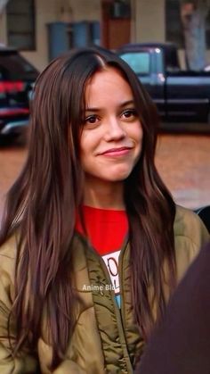 a girl with long hair is smiling for the camera